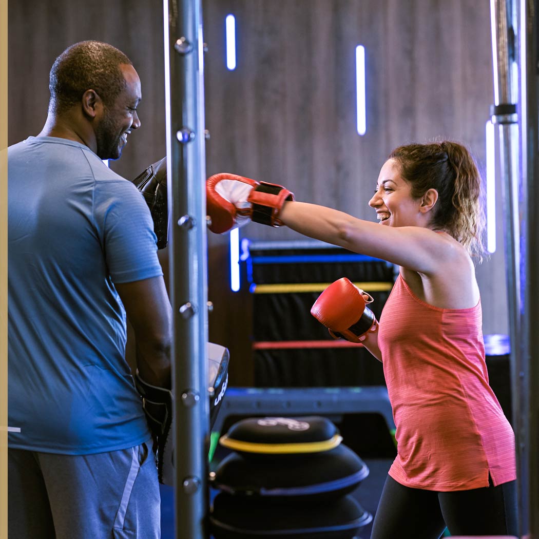 Image of man and woman doing boxing training in gym at Harbour Club