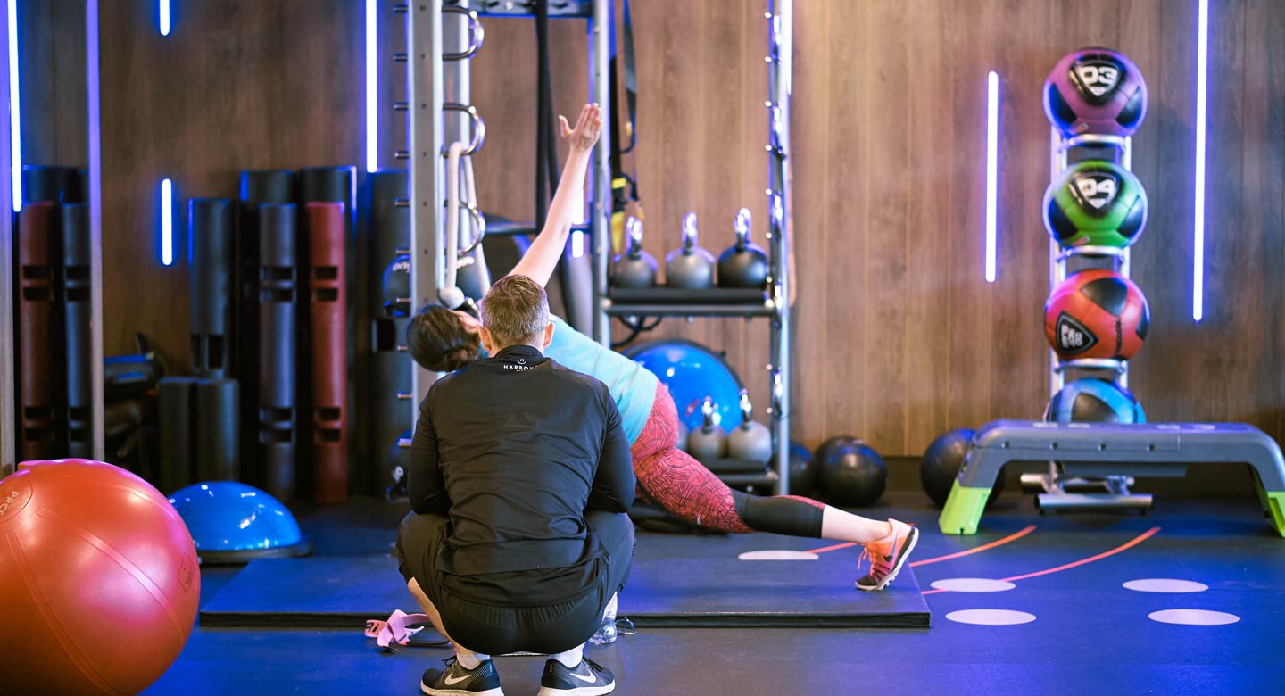 Image of woman working out with male Personal Trainer at Harbour Club