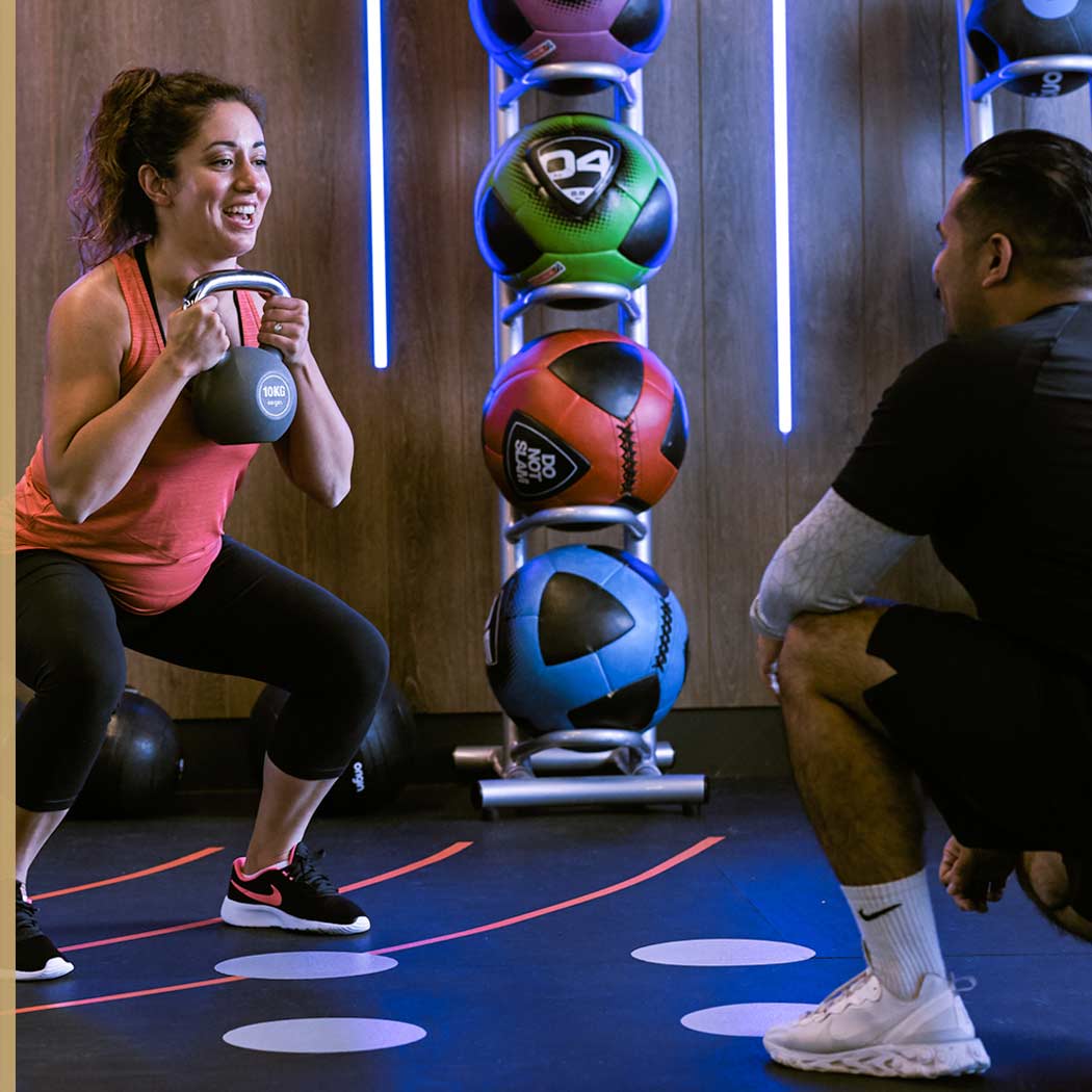 Image of woman working out with male Personal Trainer at Harbour Club