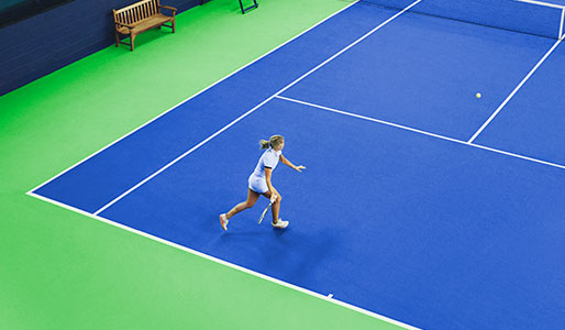 Image of a lady playing tennis at Harbour Club Chelsea